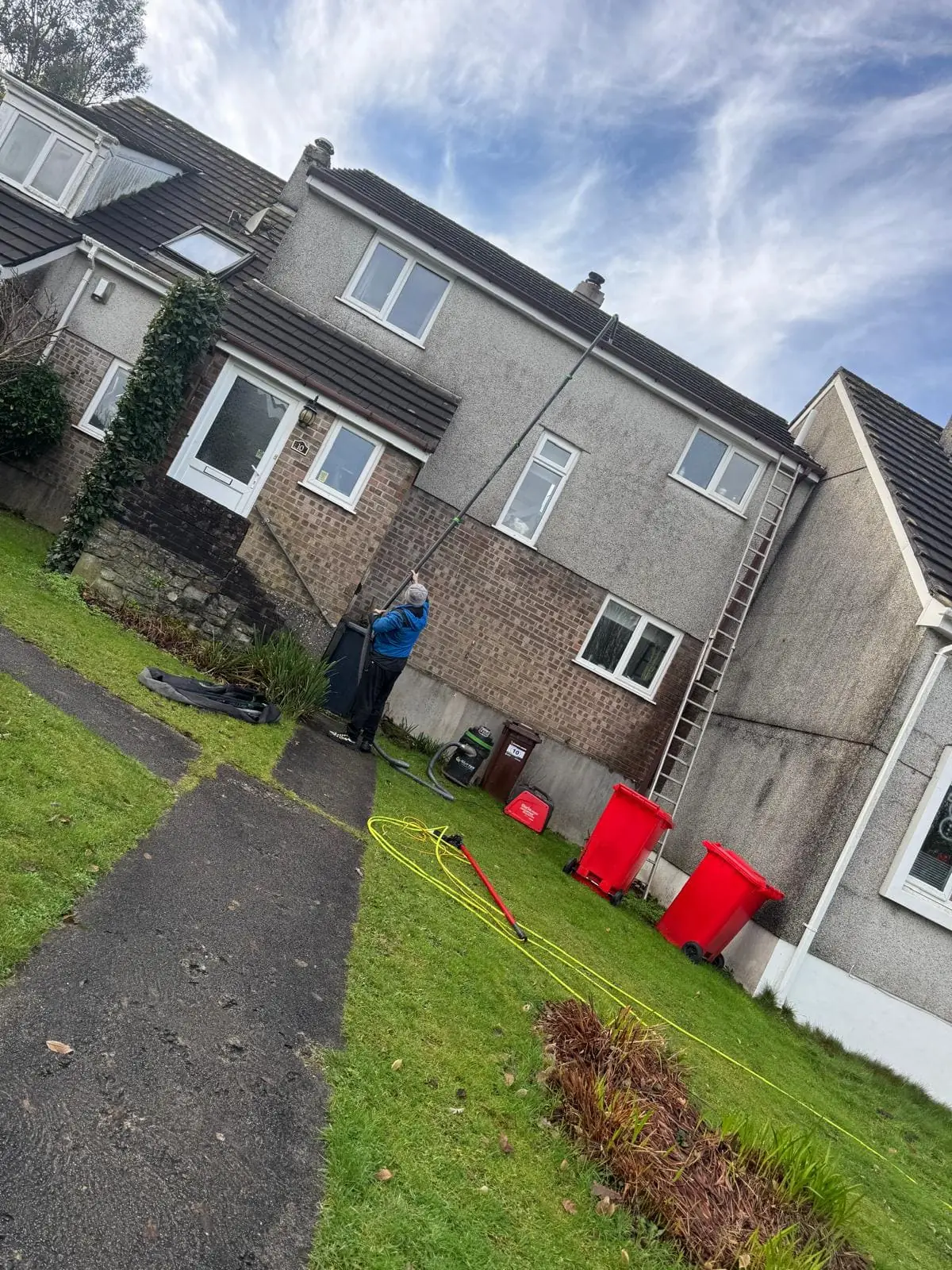 Exterior cleaning in action with professional pressure washing equipment
