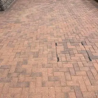 Pressure washing patio slabs to remove algae and moss